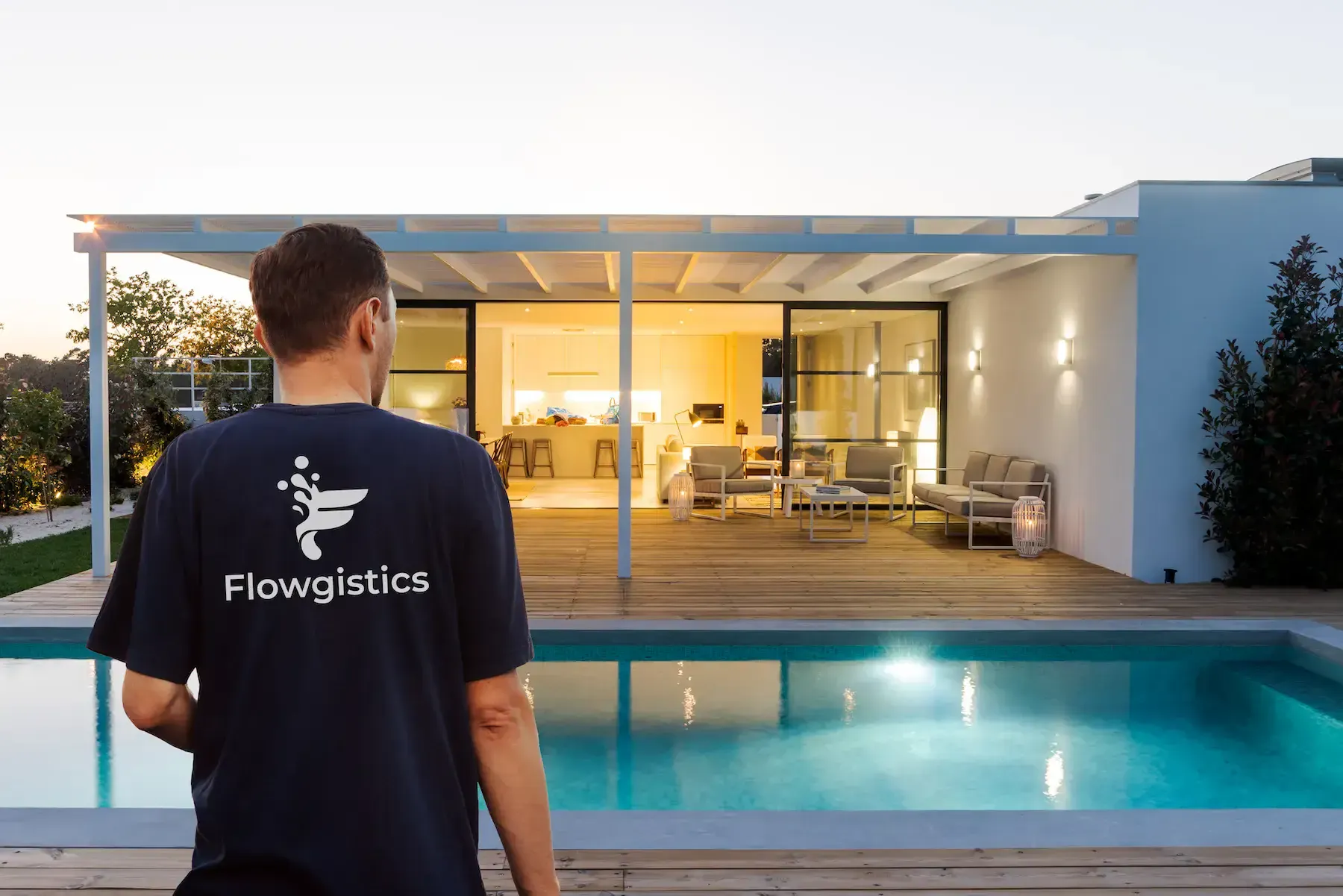 A Flowgistics employee looks over a luxury swimming pool